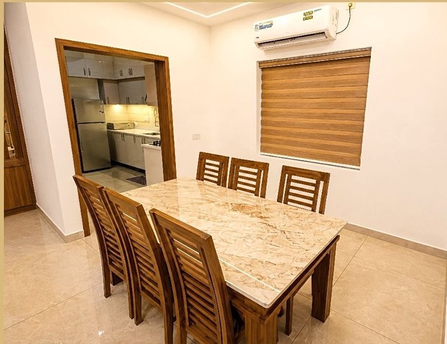 Dining area with marble-top table seating six guests