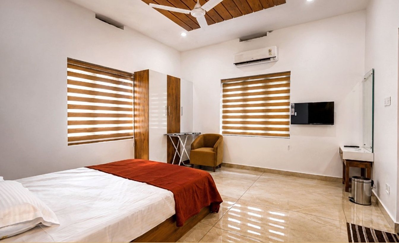 Master bedroom with wooden ceiling detail and smart TV